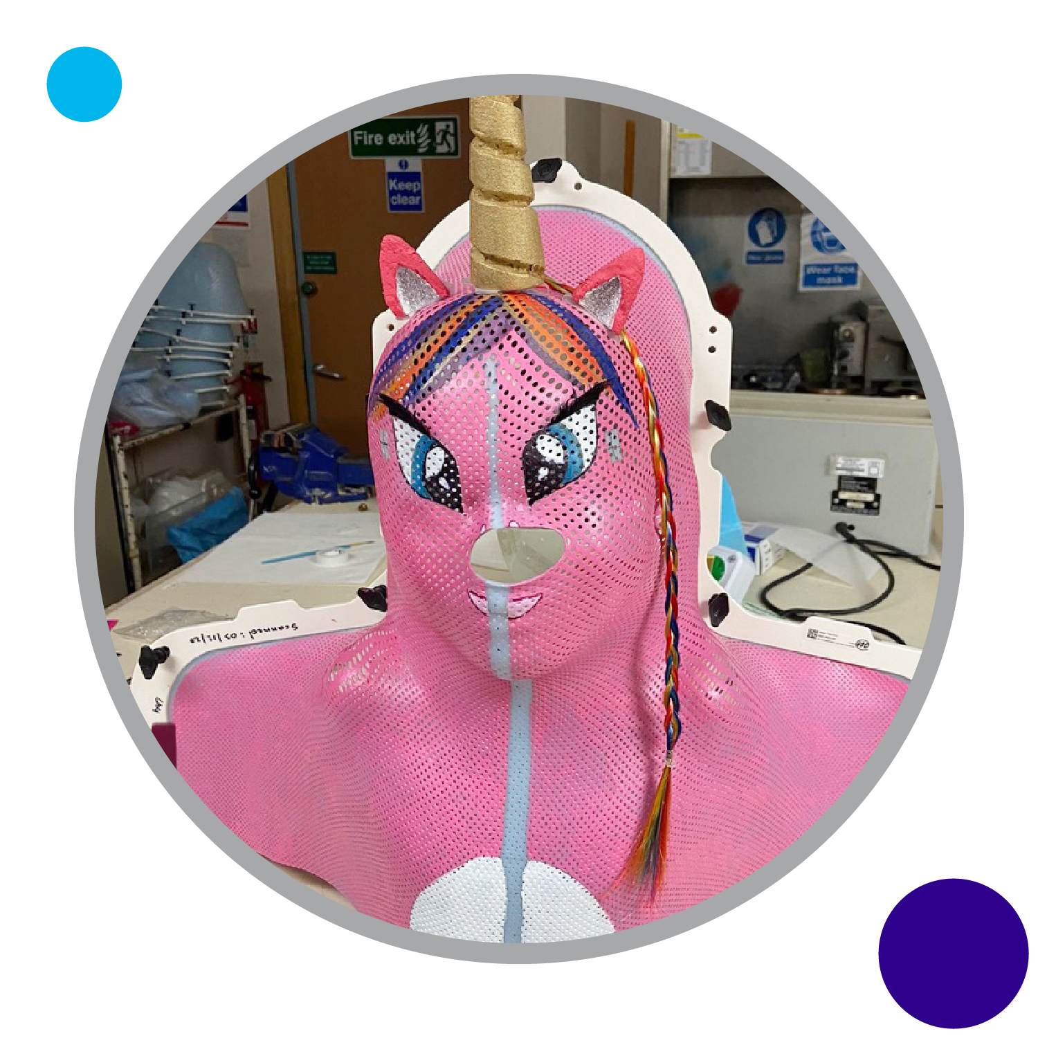 A child's radiotherapy mask decorated to look like a pink unicorn.