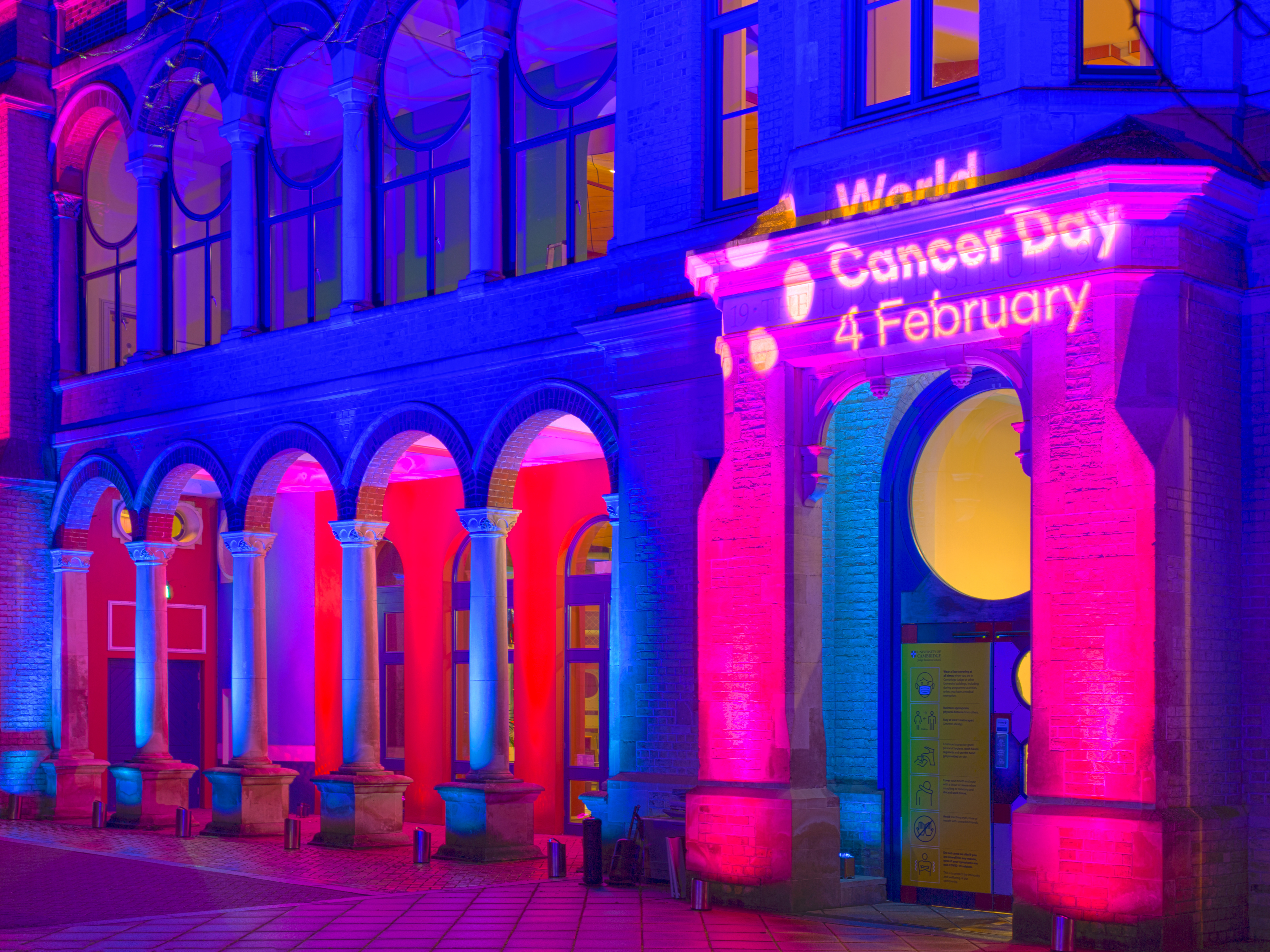 The Cambridge Judge Business School lit up for World Cancer Day