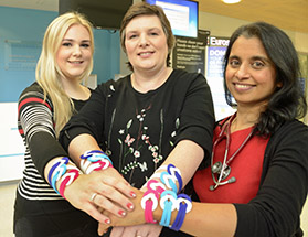 Lucy and Catharine Scott with Dr Jean Abraham, wearing World Cancer Day Unity Bands 