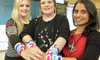 Lucy and Catharine Scott with Dr Jean Abraham, wearing World Cancer Day Unity Bands 